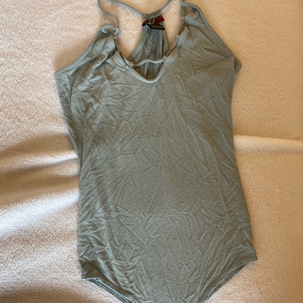 Tealish colored body suit